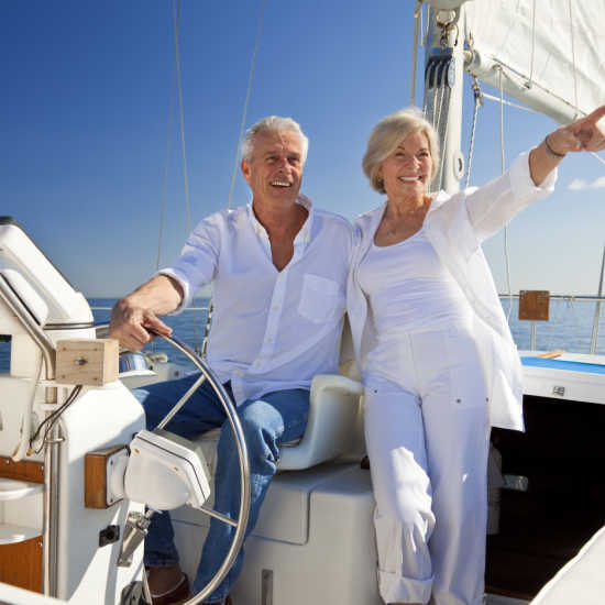 retired older couple sailing on a boat